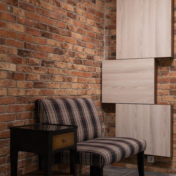 Cozy yoga studio corner with rolled mats, cushions, and soft light.